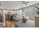 Open-concept living room with hardwood floors, modern decor, and abundant natural light at 5716 Boston Ct, Denver, CO 80238