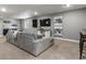 Spacious living room with a large sectional sofa and entertainment center at 5716 Boston Ct, Denver, CO 80238