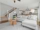 Inviting living room showcasing an open layout, staircase, and a view into the kitchen at 5716 Boston Ct, Denver, CO 80238