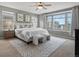 Spacious main bedroom with three large windows, ceiling fan, and carpeted floors at 5716 Boston Ct, Denver, CO 80238
