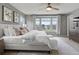 Bright main bedroom with a large window and a comfortable queen bed, modern ceiling fan, and carpet at 5716 Boston Ct, Denver, CO 80238