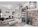 Spacious basement with stone accent, cozy bedroom and bookcase for added storage, and open concept for versatility at 2281 Oak Pl, Thornton, CO 80229