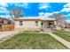 Inviting single-story home with front lawn and driveway, set against a bright blue sky at 2281 Oak Pl, Thornton, CO 80229