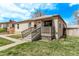 Close up of a charming front porch with comfortable seating on a sunny day at 2281 Oak Pl, Thornton, CO 80229