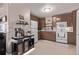 Charming kitchen with lots of counter space, white appliances, and coffee bar at 2281 Oak Pl, Thornton, CO 80229