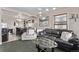 Open-concept living room and dining area with modern decor and stylish furnishings at 2281 Oak Pl, Thornton, CO 80229
