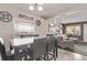 Open floor plan showing living room adjacent to dining room with lots of natural light at 2281 Oak Pl, Thornton, CO 80229