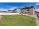 Spacious backyard featuring a well-maintained lawn and a cozy patio area for outdoor entertaining at 12835 Randles Ave, Parker, CO 80134