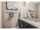 Elegant bathroom with dual sinks, granite countertop, and framed mirror at 12835 Randles Ave, Parker, CO 80134