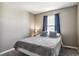 Inviting bedroom with a comfortable bed, blue curtains, and a soft, welcoming atmosphere at 12835 Randles Ave, Parker, CO 80134