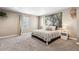 Spacious bedroom with a large picture window, neutral tones, and soft carpet at 12835 Randles Ave, Parker, CO 80134