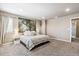Bright bedroom featuring a large picture window, neutral tones, and plush carpet at 12835 Randles Ave, Parker, CO 80134
