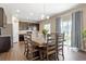 Dining table with seating for eight with a view of the sliding glass door and kitchen at 12835 Randles Ave, Parker, CO 80134