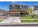 Two story home featuring stone accents, well manicured lawn and attached two car garage at 12835 Randles Ave, Parker, CO 80134