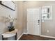 Foyer with a side table, white door and an accent window with decorative stone at 12835 Randles Ave, Parker, CO 80134