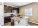 Kitchen island with granite countertops, sink, and view of the stainless steel appliances at 12835 Randles Ave, Parker, CO 80134