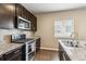 Kitchen featuring granite countertops, stainless steel appliances, and view of the window at 12835 Randles Ave, Parker, CO 80134