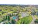 An aerial view of a pool, tennis courts, a cabana, and lush landscaping, within a picturesque residential area at 485 Sapphire Dr, Castle Rock, CO 80108