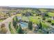 An aerial view of a pool, tennis courts, a cabana, and lush landscaping, offering a luxurious recreational space at 485 Sapphire Dr, Castle Rock, CO 80108