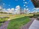Expansive backyard featuring a well-manicured lawn, decorative gravel, and a white fence perimeter at 485 Sapphire Dr, Castle Rock, CO 80108