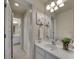 Well-lit bathroom featuring a large mirror, white cabinets, and neutral decor with dual sinks at 485 Sapphire Dr, Castle Rock, CO 80108