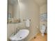 Stylish powder room showcasing a pedestal sink, decorative accessories, and modern fixtures at 485 Sapphire Dr, Castle Rock, CO 80108