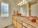 Clean, bright bathroom with decorative window and spacious countertop and ample lighting at 485 Sapphire Dr, Castle Rock, CO 80108