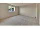 Spacious bedroom with carpet flooring, a large window offering natural light and neutral walls at 485 Sapphire Dr, Castle Rock, CO 80108