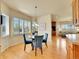 Cozy dining area bathed in natural light, featuring blue chairs and a view of the landscaped outdoors at 485 Sapphire Dr, Castle Rock, CO 80108