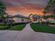 Inviting single-story home with manicured lawn and a charming walkway, showcasing warm exterior lighting at 485 Sapphire Dr, Castle Rock, CO 80108