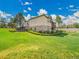 Lush backyard with manicured landscaping, beautiful stonework, with an expansive yard and white fencing at 485 Sapphire Dr, Castle Rock, CO 80108