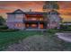 A home exterior showcasing a stone facade, second-story deck, walk-out basement, and manicured backyard at 485 Sapphire Dr, Castle Rock, CO 80108