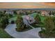 Stunning home with a circular driveway and meticulous landscaping, set against a beautiful sunset backdrop at 485 Sapphire Dr, Castle Rock, CO 80108