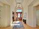 Grand foyer featuring a high ceiling, elegant chandelier, and a beautifully paneled wooden front door at 485 Sapphire Dr, Castle Rock, CO 80108