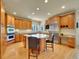 Bright, gourmet kitchen with an island cooktop, stainless steel appliances, and custom wood cabinets at 485 Sapphire Dr, Castle Rock, CO 80108