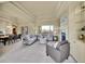 Bright living room with tray ceilings, a fireplace, and an open layout connecting to the dining area at 485 Sapphire Dr, Castle Rock, CO 80108