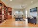 Inviting living room featuring a custom bookcase, neutral furniture, and shuttered windows at 485 Sapphire Dr, Castle Rock, CO 80108