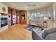 Cozy living room featuring a fireplace, built-in bookshelves, and abundant natural light from shuttered windows at 485 Sapphire Dr, Castle Rock, CO 80108