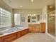 Elegant main bathroom featuring a soaking tub, glass block window, and walk-in shower at 485 Sapphire Dr, Castle Rock, CO 80108