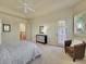 Serene main bedroom with tray ceilings, a decorative door, and access to the en suite bathroom at 485 Sapphire Dr, Castle Rock, CO 80108