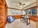Wood paneled home office with built-in shelving and plantation shutters at 485 Sapphire Dr, Castle Rock, CO 80108