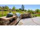 Outdoor kitchen and bar area with a built-in grill, ideal for backyard gatherings and summer barbecues at 9688 Chesapeake St, Highlands Ranch, CO 80126
