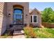 Inviting front entrance with brickwork, a large arched window, and landscaped garden beds, enhancing curb appeal at 9688 Chesapeake St, Highlands Ranch, CO 80126