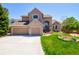 Beautiful two-story home with a large driveway and a well-maintained front yard, showcasing its curb appeal at 9688 Chesapeake St, Highlands Ranch, CO 80126