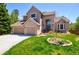 Charming two-story home featuring a manicured lawn, brick accents, and a spacious three-car garage at 9688 Chesapeake St, Highlands Ranch, CO 80126