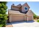 Spacious three-car garage offering ample parking and storage, complemented by the home's exterior design at 9688 Chesapeake St, Highlands Ranch, CO 80126
