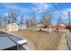 Spacious backyard featuring sheds, garden beds, seating, and walking paths at 4040 S Inca St, Englewood, CO 80110