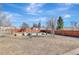 Wide backyard with garden beds, wood fence and shed at 4040 S Inca St, Englewood, CO 80110