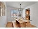 Inviting dining area with a wooden table, bench seating, and stylish light fixture at 4040 S Inca St, Englewood, CO 80110
