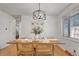 Stylish dining area featuring a wooden table, decorative place settings, and modern chandelier at 4040 S Inca St, Englewood, CO 80110